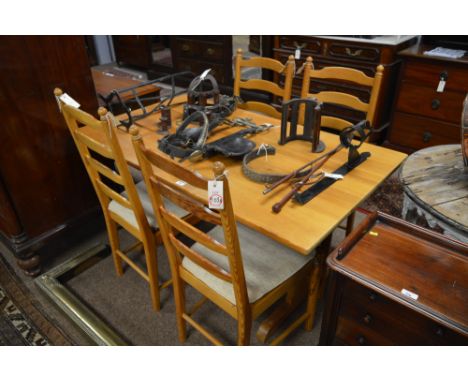 A small pine refectory style table, 137 x 76cms; and four matching pine ladder back chairs, with slatted seats and cushions.