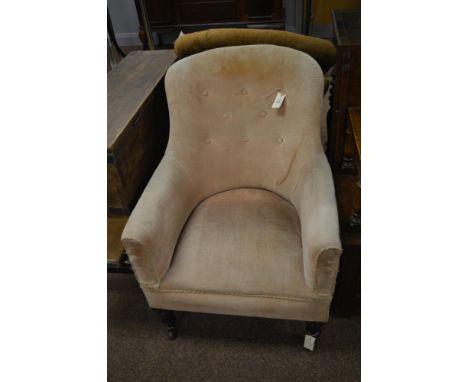 A Victorian button back easy armchair, upholstered in peach fabric with button back, padded arms and raised on turned legs te
