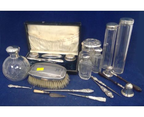 A quantity of silver mounted dressing items, including hat pin bottles, scent bottles, manicure items; a pair of silver candl