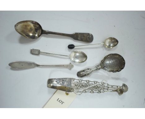 A George III silver caddy spood, by John Bettridge, Birmingham 1817, with scrolling handle and bright cut leaf design; a pair