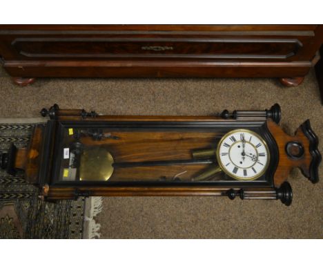 A Early 20th century mahogany Vienna wall clock, with enamel dial and seconds ring and roman numerals, contained within a ros