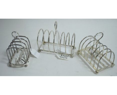 Three silver toast racks, make is include William Hutton and Sons, Carrington &amp; Co and another (overstruck), one five bar