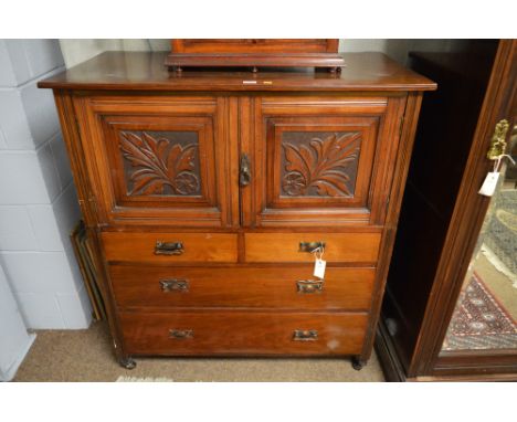 An Edwardian mahogany cupboard, the rectangular top above an arrangement of two foliate carved panel doors above two short an