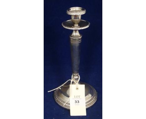 An 800 standard silver candlestick, with gadrooned rims and loaded base.