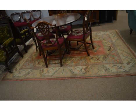 An early 20th century Persian carpet, with pink ground and with a column of five central medallions contained within a flower