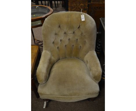 A Victorian easy armchair, the curved top above a button back and sides raised on turned and tapering legs raised terminating