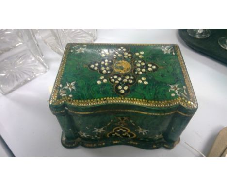 A Victorian Papier Mache tea caddy with faux malachite decoration enriched with flowers and gilt beading.