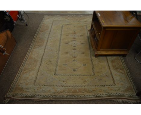 A cream ground Persian carpet, with five central medallion contained with in a border of stylised flowerheads 225 x 162cms