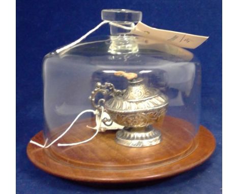 A Victorian silver table lighter by Stuart Clifford, London 1891, decorated with leaf scrolls under glass dome, on turned tea