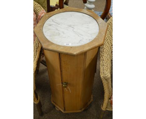 A 20th century hexagonal and marble topped bedside cabinet, the marble inset top above a central cupboard door enclosing a si