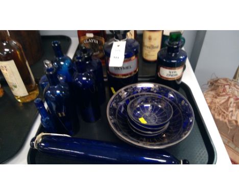 A 19th Century blue glass rolling pin 'Forget me not'; Vintage blue glass chemists and other bottles; and blue glass bowls.