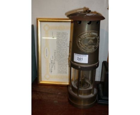 Brass miner's type lamp by Thomas &amp; Williams Ltd., (COA in frame)