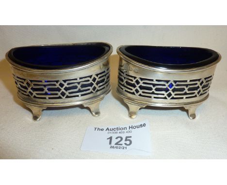 Pair of pierced silver salts with blue glass liners by the Haseler Brothers. One with Birmingham hallmarks for 1886, the othe