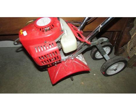 A petrol garden tool which will take different attachments. (Collect only) 