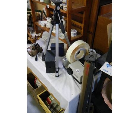 A Hanimex slide projecter, a screen, a camera tripod and two box camera's. 