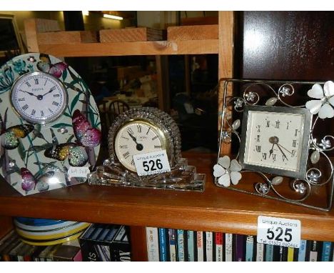 A crystal glass clock and two others. 