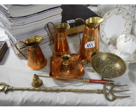 A set of three graduated copper jugs, brass toasting fork etc., 