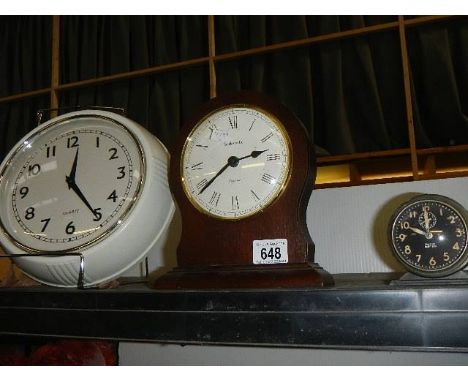 A wall clock and two other clocks. 