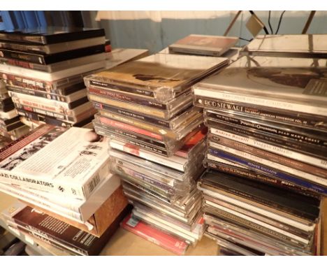 Shelf of assorted DVDs CDs videos etc