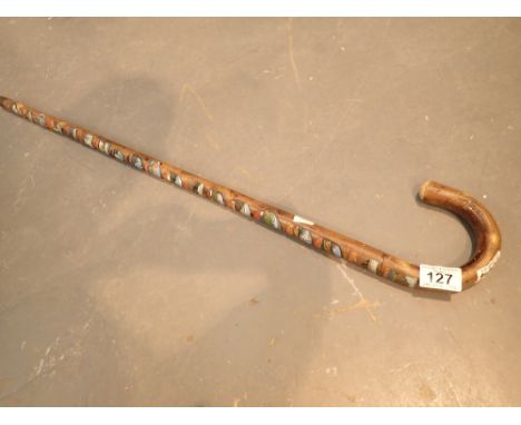 Souvenier walking stick with nineteen badges 