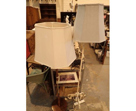 Wrought iron standard lamp with scroll work tripod base and a teak and brass standard lamp both with shades