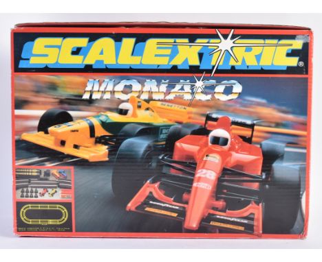 A vintage Scalextric slot car racing set No. C489 Monaco. The set with x2 Formula One racing cars, x1 additional (unrelated) 