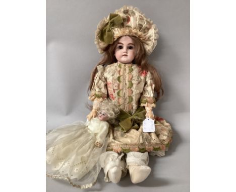 German 23” bisque shoulder head doll with composition arms and a good articulated jointed white kid body, good hands and dres