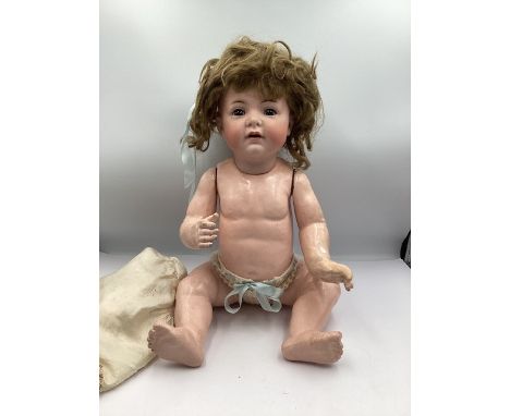 Antique Kammer and Reinhardt Character baby 128 with dark brown eyes and original wig and pate and asymetrical body with good