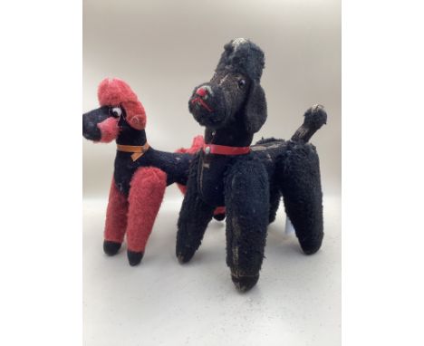 A  vintage pair of Merrythought poodles, glass eyes; another similar in red-there are no labels remaining and both are standi