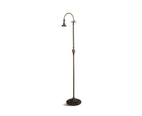 A BRASS STANDARD LAMPthe curved adjustable light fitting supported on cylindrical upright brass shaft on moulded circular bas