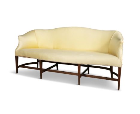 A MAHOGANY FRAMED HUMPBACK SOFA IN HEPPLEWHITE STYLEserpentine seat on eight mahogany and inlaid tapering legs joined by a st