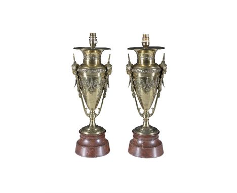 A PAIR OF POLISHED BRASS AMPHORA SHAPED TABLE LAMPS,each with female mask side handles, embossed with interlinked swags and s