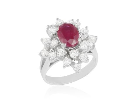 A RUBY AND DIAMOND DRESS RING, the oval-shaped ruby within a surround of brilliant-cut diamonds, mounted in 18K gold, diamond