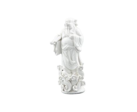 A CHINESE BLANC DE CHINE FIGURE OF A BUDDHIST DEITY STANDING IN CLOUDSDehua, 19th Century, modelled standing on a stylized cl