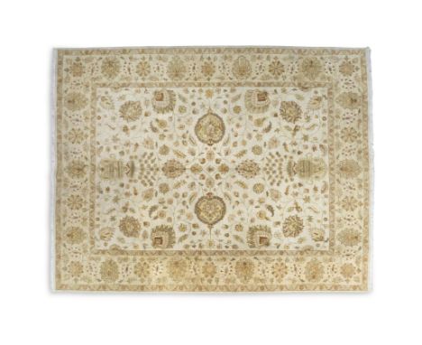 A ZIEGLER PATTERN WOOL RUG, the rectangular field woven with intertwined tendrils and flower heads on a cream ground, within 