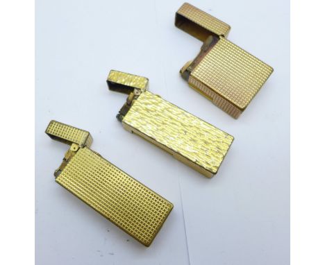 Two Dunhill lighters and one Dupont lighter 