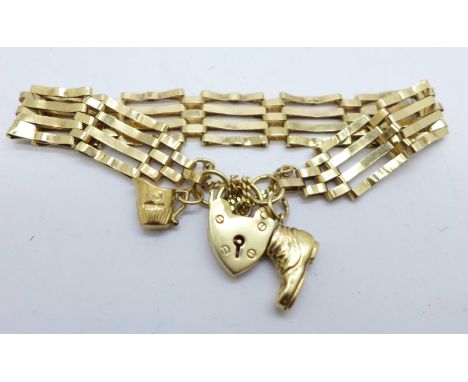 A 9ct gold gate bracelet with two 9ct gold charms, 11g 