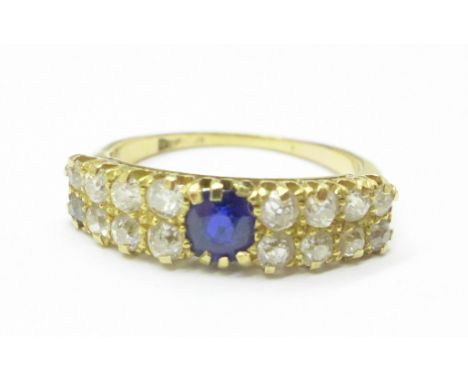 A yellow metal, sixteen stone diamond and single sapphire ring, mark worn, (tests as 18ct gold), approximately 1carat diamond