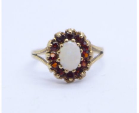 A 9ct gold, opal and garnet ring, 1.9g, M 