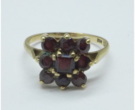 A 9ct gold and garnet nine stone ring, 2.7g, R 