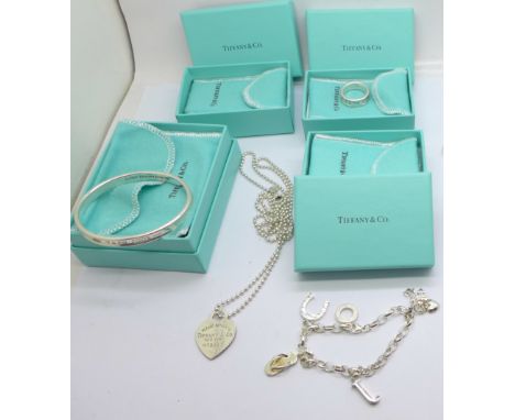 A Tiffany &amp; Co. silver bangle, pendant and chain and ring, boxed, and a Sabo charm bracelet, ring size M