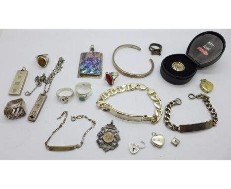 Two silver identity bracelets, two silver ingot pendants, a silver 'My Last Rolo', boxed, a silver bangle, six rings, etc., (