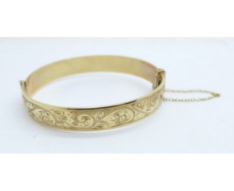 A '1/5th 9ct rolled gold' bangle 