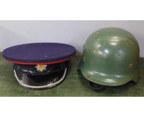 A bandsman's peaked cap and a Spanish Army helmet, a/f 