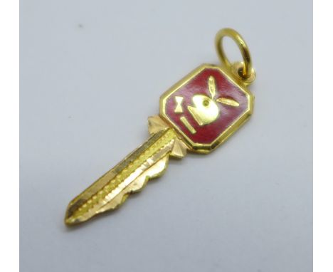 A yellow metal and enamel Playboy key charm 