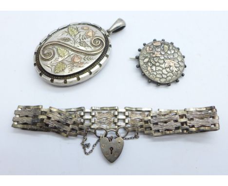 A Victorian silver locket with gold applied decoration, Birmingham 1882, by Adie &amp; Lovekin, 33mm x 43mm, a brooch and a s