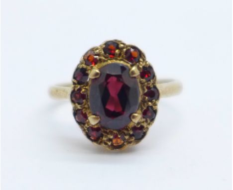 A 9ct gold and garnet cluster ring, 2.9g, K 