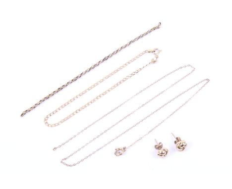 A vintage Italian '14K' filed-curb bracelet, two yellow metal necklaces and a pair of knot earrings. The curb bracelet stampe