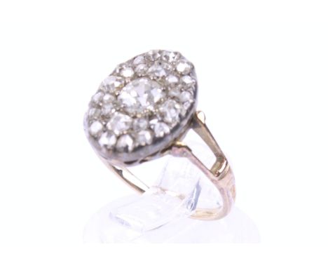 A late Victorian gold and diamond oval cluster ring. The oval head set with old-cut, old-mine cut and rose diamonds (one rose