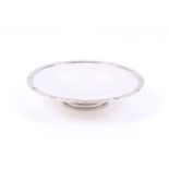 A silver tazza or cake stand on foot.